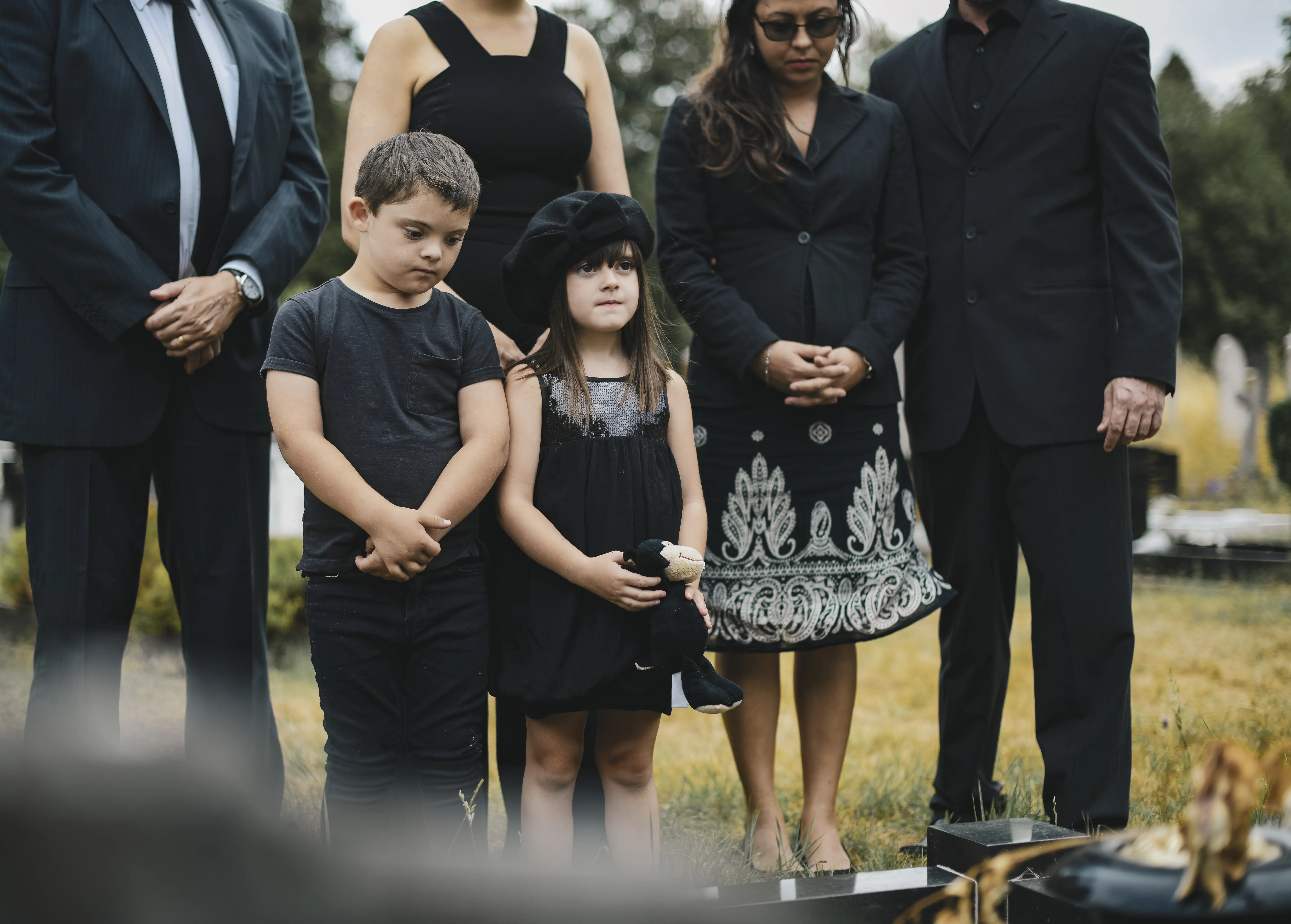 Sad Grandkids Standing by the Grave - Redeemed Life Counseling