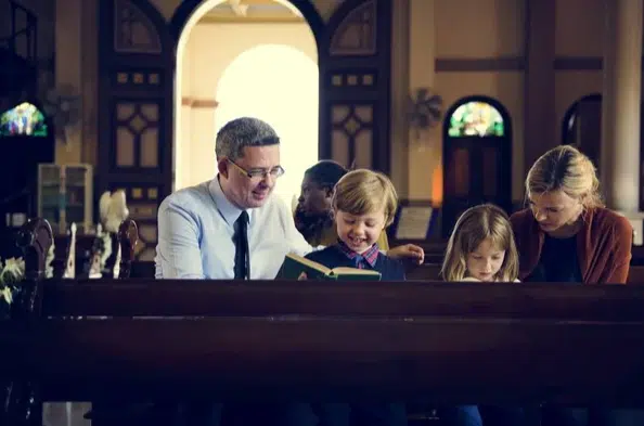 family reading the Bible at church
