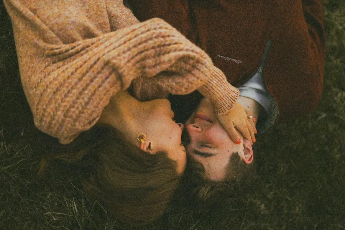 Christian couple lying in grass representing spiritual intimacy and shared faith in relationships